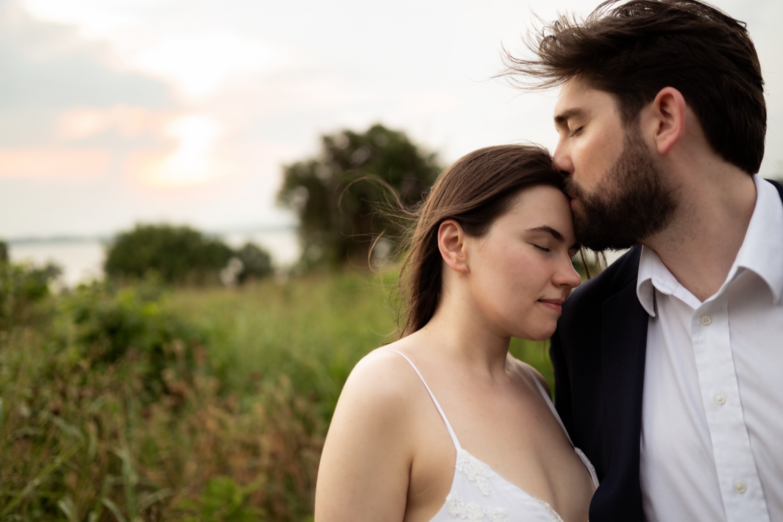 Engaged couple foreheads together at sunset in Dallas